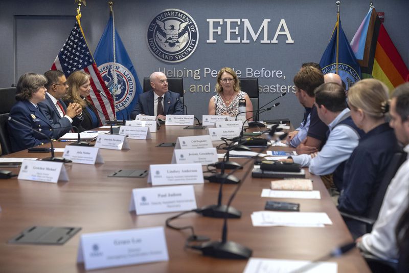Homeland Security Secretary Alejandro Mayorkas, center left, listens as Federal Emergency Management Agency administrator Deanne Criswell speaks during a briefing on the 2024 hurricane and wildfire outlook at FEMA headquarters on Friday, June 21, 2024, in Washington. (AP Photo/Mark Schiefelbein)