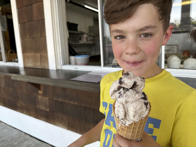 Silas Pociask, 9, of Deerfield, N.H., enjoys a "kiddie"-sized ice cream cone at Johnson's Dairy Bar in Northwood, N.H., on Thursday, June 20, 2024. (AP photo/Holly Ramer)