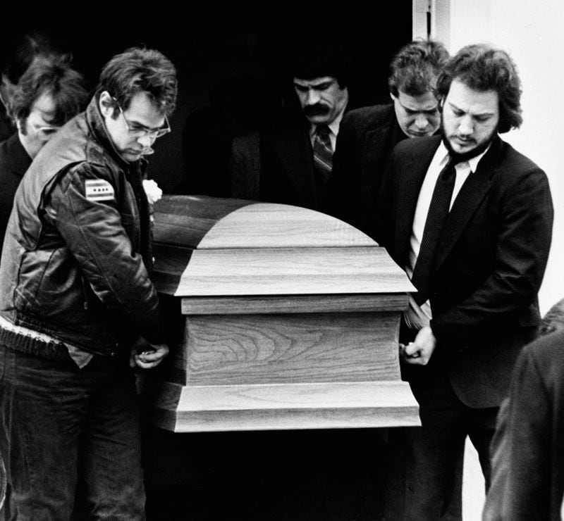 FILE - The coffin for actor John Belushi is carried out of the Congregational Church by pallbearers Dan Aykroyd, left, and Belushi's brother Jim Belushi, right, following funeral services in West Tinsbury, Mass., on March 9, 1982. (AP Photo/Dave Tenenbaum, File)