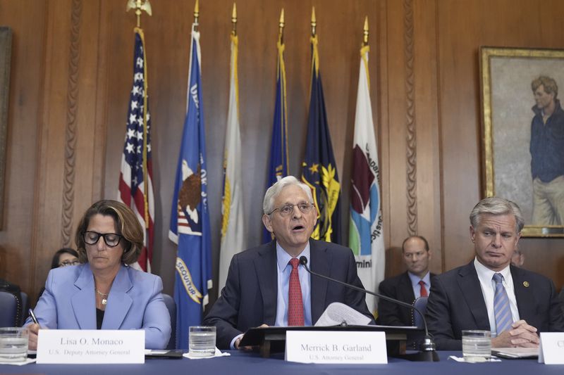 Attorney General Merrick Garland speaks during a meeting of the Justice Department's Election Threats Task Force, at the Department of Justice, Wednesday, Sept. 4, 2024, in Washington, with Deputy Attorney General Lisa Monaco, left, and FBI Director Christopher Wray, right. (AP Photo/Mark Schiefelbein)