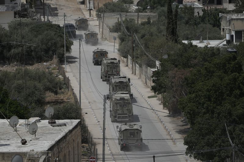 Israeli armoured vehicles move during a military operation in the West Bank Jenin refugee camp, Saturday, Aug. 31, 2024. (AP Photo/Majdi Mohammed)