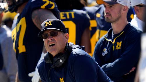 FILE - Michigan head coach Jim Harbaugh, front left, watches against Rutgers as analytics assistant Connor Stalions, right, looks on during an NCAA college football game in Ann Arbor, Mich., Sept. 23, 2023. Stalions is set to share his side of the story from an alleged sign-stealing scheme within Michigan’s football team before it went on to win the national championship. (AP Photo/Paul Sancya, File)