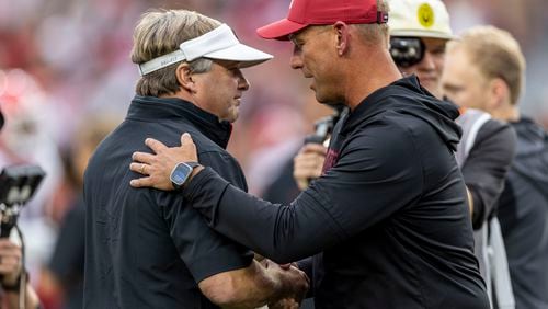 Georgia head coach Kirby Smart, left, and Alabama head coach Kalen DeBoer meet at midfield before an NCAA college football game, Saturday, Sept. 28, 2024, in Tuscaloosa, Ala. (AP Photo/Vasha Hunt)