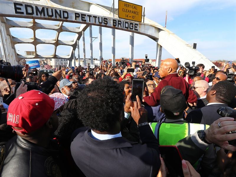 CIVIL RIGHTS ICON RETURNS || March 1, 2020, Selma: A group of men hoist U.S. Rep. John Lewis, D-Atlanta, on their shoulders so he can speak to the crowd of marchers at the Edmund Pettus Bridge during Selma's re-enactment of Bloody Sunday. (Curtis Compton ccompton@ajc.com)