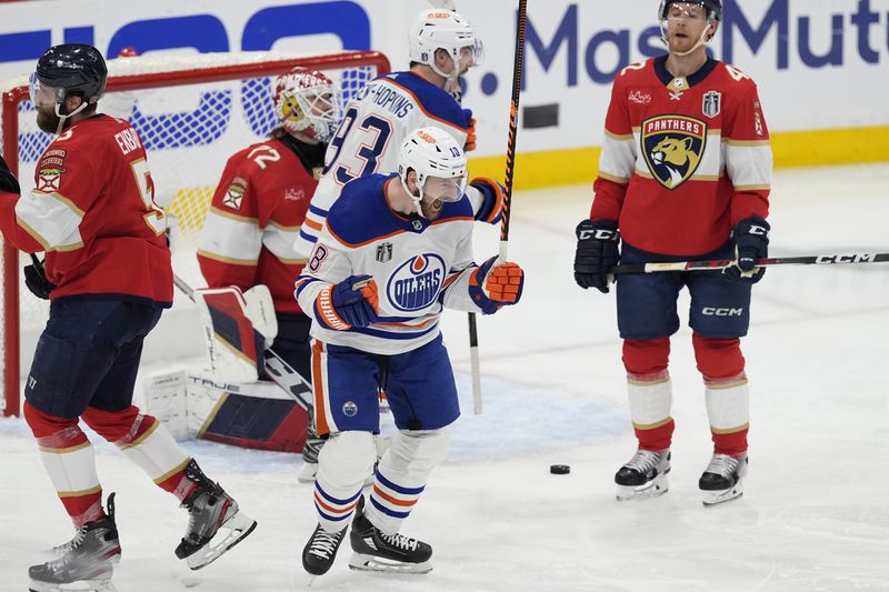 Edmonton Oilers left wing Zach Hyman (18) celebrates after scoring a goal during the second period of Game 5 of the NHL hockey Stanley Cup Finals against the Florida Panthers, Tuesday, June 18, 2024, in Sunrise, Fla. (AP Photo/Rebecca Blackwell)