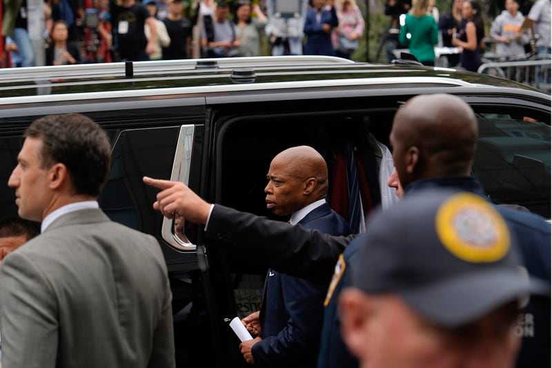 New York City mayor Eric Adams, center, departs Manhattan federal court after an appearance, Friday, Sept. 27, 2024, in New York. (AP Photo/Julia Demaree Nikhinson)