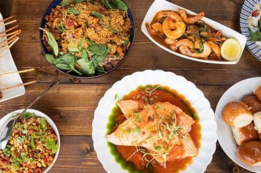 A spread of food served at one of the family dining experiences at the 2023 Family Reunion, hosted by Chef Kwame Onwuachi at Salamander Middleburg in Virginia.