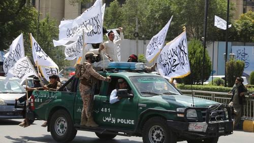 Taliban fighters celebrate the third anniversary of the withdrawal of US-led troops from Afghanistan, in Kabul, Afghanistan, Wednesday, Aug. 14, 2024. (AP Photo/Siddiqullah Alizai)