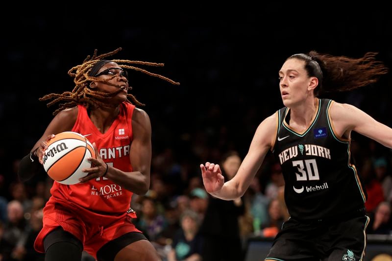 Atlanta Dream guard Rhyne Howard drives past New York Liberty forward Breanna Stewart (30) during the second half of first-round WNBA basketball playoff game, Tuesday, Sept. 24, 2024, in New York. The Liberty won 91-82 to clinch the series 2-0. (AP Photo/Adam Hunger)