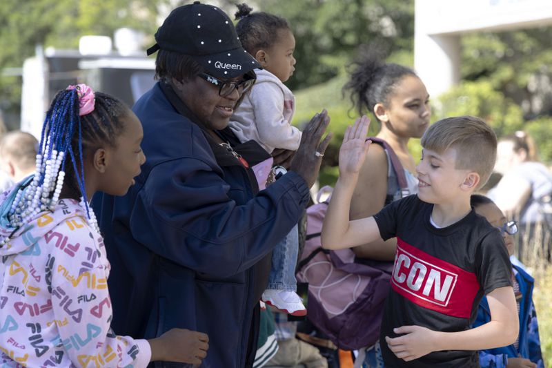 Kids and adults take part in a back to school health fair in Milwaukee, on Saturday Aug. 10, 2024. (AP Photo/Jeffrey Phelps)