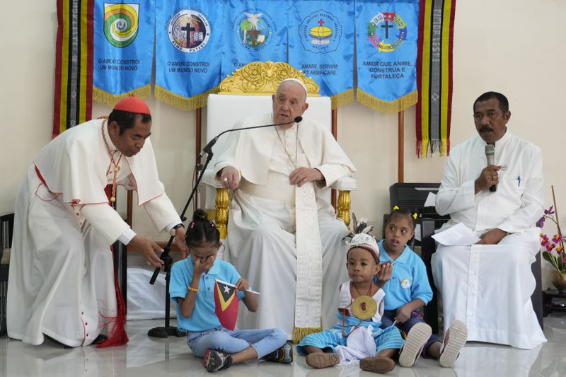 Pope Francis speaks during a visit at the 'Irmas ALMA' (Sisters of the Association of Lay Missionaries) School for Children with Disabilities in Dili, East Timor, Tuesday, Sept. 10, 2024. Pope Francis has indirectly acknowledged the abuse scandal in East Timor involving its Nobel Peace Prize-winning independence hero Bishop Carlos Filipe Ximenes Belo. At left is Archbishop of Dili Cardinal Virgilio do Carmo da Silva. (AP Photo/Gregorio Borgia)