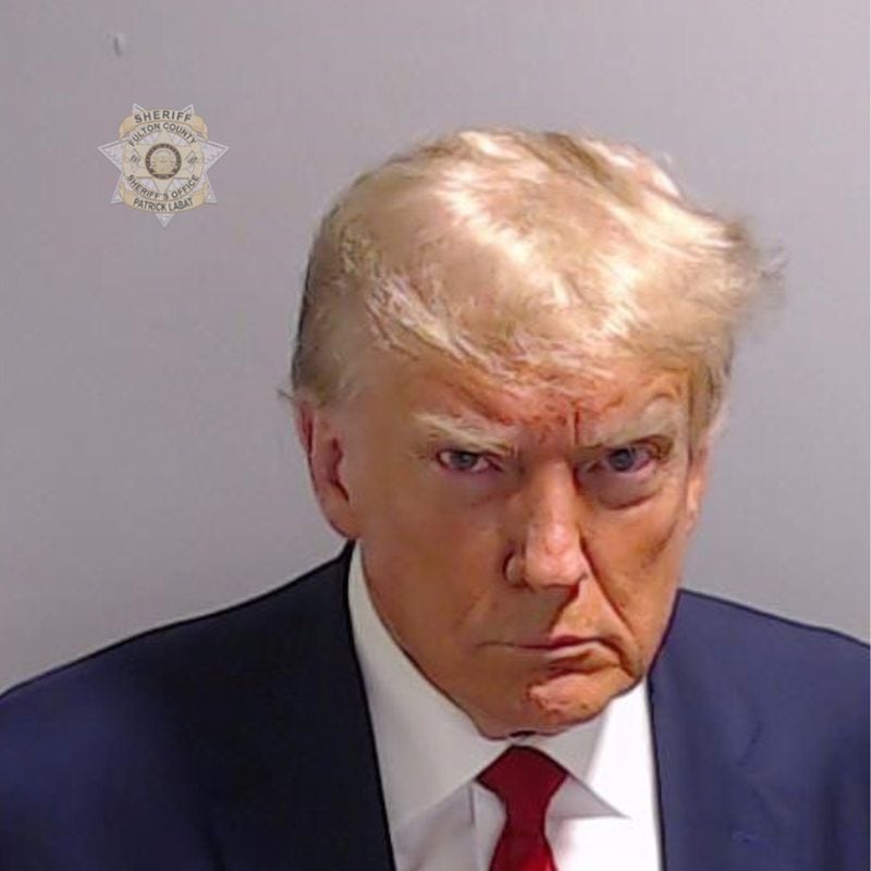 In this handout provided by the Fulton County Sheriff's Office, former U.S. President Donald Trump poses for his booking photo at the Fulton County Jail on Aug. 24, 2023, in Atlanta, Georgia. Trump was booked on 13 charges related to an alleged plan to overturn the results of the 2020 presidential election in Georgia. Trump and 18 others facing felony charges have been ordered to turn themselves in to the Fulton County Jail by Aug. 25. (Fulton County Sheriff's Office/Getty Images/TNS)