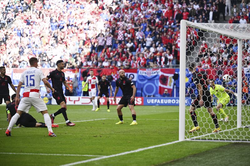Albania's Klaus Gjasula, fourth from left, scores an own goal during a Group B match between Croatia and Albania at the Euro 2024 soccer tournament in Hamburg, Germany, Wednesday, June 19, 2024. ( Sina Schuldt/dpa via AP)