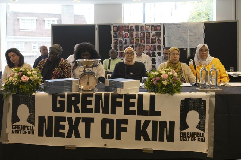 Relatives of the deceased and people directly affected by the Grenfell Tower fire react to the final report into the fire being released in London, Wednesday, Sept. 4, 2024. The report on the fire in which 72 people were killed in June 2017, says decades of failure by government and industry made the high-rise a "death trap". (AP Photo/Frank Augstein)