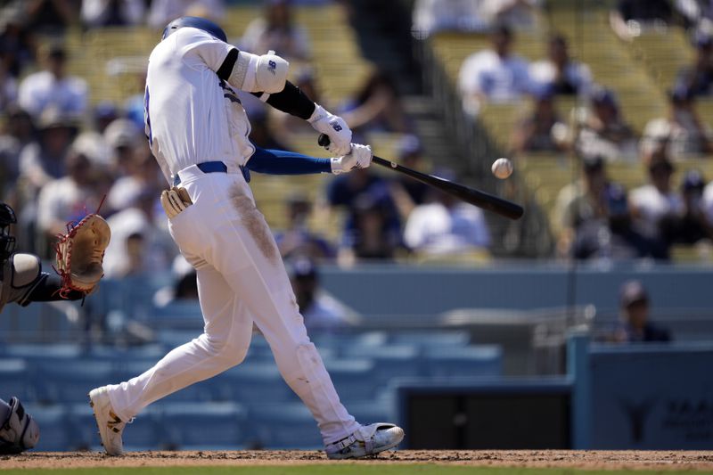 Los Angeles Dodgers' Shohei Ohtani hits a solo home run during the fifth inning of a baseball game against the Cleveland Guardians, Sunday, Sept. 8, 2024, in Los Angeles. (AP Photo/Mark J. Terrill)