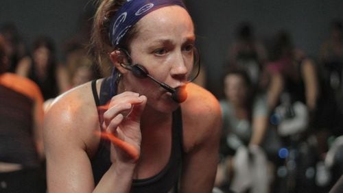 Instructor Kate Hickl leads the class on a 45 minute workout in near total darkness. Flywheel Stadium Cycling is a new indoor cycling gym in Atlanta. Sessions are held in the dark, led by an instructor.