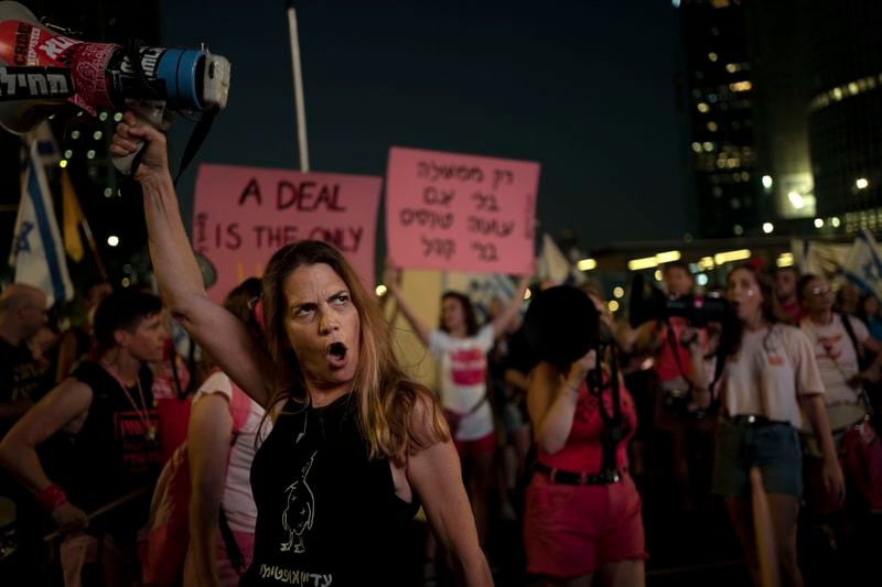 Activists and relatives of hostages held by Hamas militants in the Gaza Strip call for their immediate release and to protest against Israeli Prime Minister Benjamin Netanyahu's government in Tel Aviv, Israel, Saturday, Aug. 24, 2024. (AP Photo/Maya Alleruzzo)