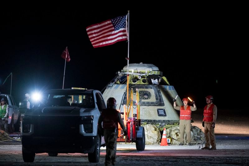 In this photo provided by NASA, Boeing and NASA teams work around NASA's Boeing Crew Flight Test Starliner spacecraft after it landed uncrewed, Friday, Sept. 6, 2024, at White Sands, New Mexico, after undocking from the International Space Station. (Aubrey Gemignani/NASA via AP)