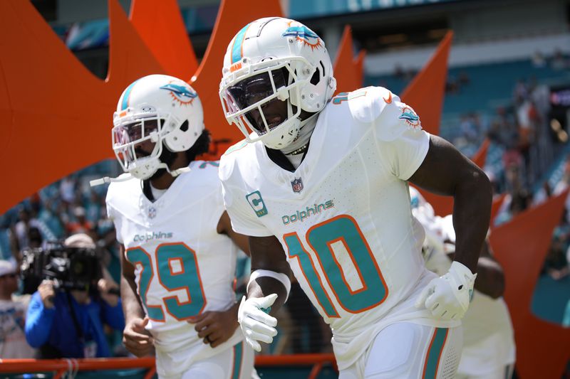 Miami Dolphins wide receiver Tyreek Hill (10) enters the field before an NFL football game against the Jacksonville Jaguars, Sunday, Sept. 8, 2024, in Miami Gardens, Fla. (AP Photo/Rebecca Blackwell)