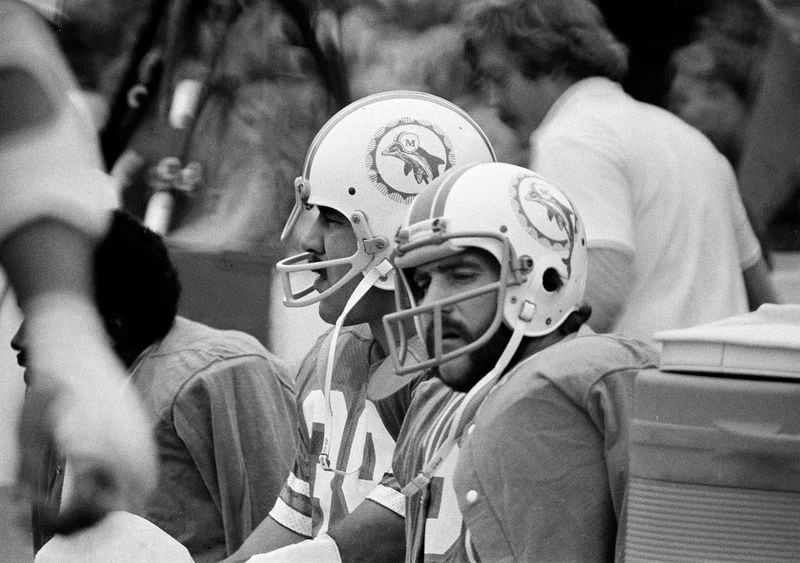 FILE - Miami Dolphins full back Larry Csonka, left, and halfback Jim Kiick, right, watch the action as the Minnesota Vikings have the ball during the Super Bowl game Jan. 13, 1974, in Houston. (AP Photo/Charles Knoblock, File)