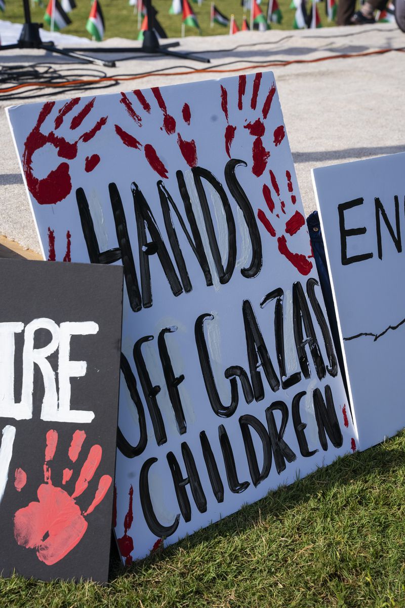 A sign reading "Hands Off Gaza's Children" is displayed at a memorial on the Georgia Tech campus green on Tuesday, Aug. 20, 2024, for Palestinians affected by the Gaza conflict. (Olivia Bowdoin for the Atlanta Journal-Constitution). 