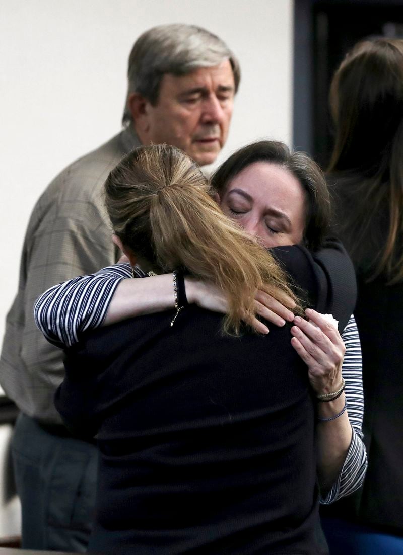 Rose Marie Kosmetatos, facing, hugs her attorney Lori Laird on Monday, Aug. 19, 2024, after a split jury found her and husband, Antonios Pagourtzis, not financially responsible for the 2018 shooting at Santa Fe High School, Monday, Aug. 19, 2024, at the Galveston County Courthouse in Galveston, Texas. (Jennifer Reynolds/The Galveston County Daily News via AP, Pool)