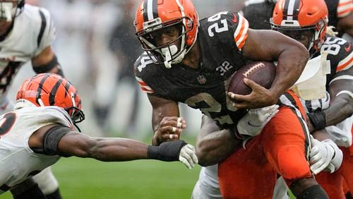 FILE - Cleveland Browns running back Nick Chubb (24) is pressured by Cincinnati Bengals safety Dax Hill, left, during an NFL football game, Sept. 10, 2023, in Cleveland. (AP Photo/Sue Ogrocki, File)