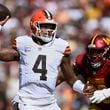 Cleveland Browns quarterback Deshaun Watson (4) looks to pass under pressure from Washington Commanders defensive tackle Phidarian Mathis (98) during the first half of an NFL football game in Landover, Md., Sunday, Oct. 6, 2024. (AP Photo/Nick Wass)