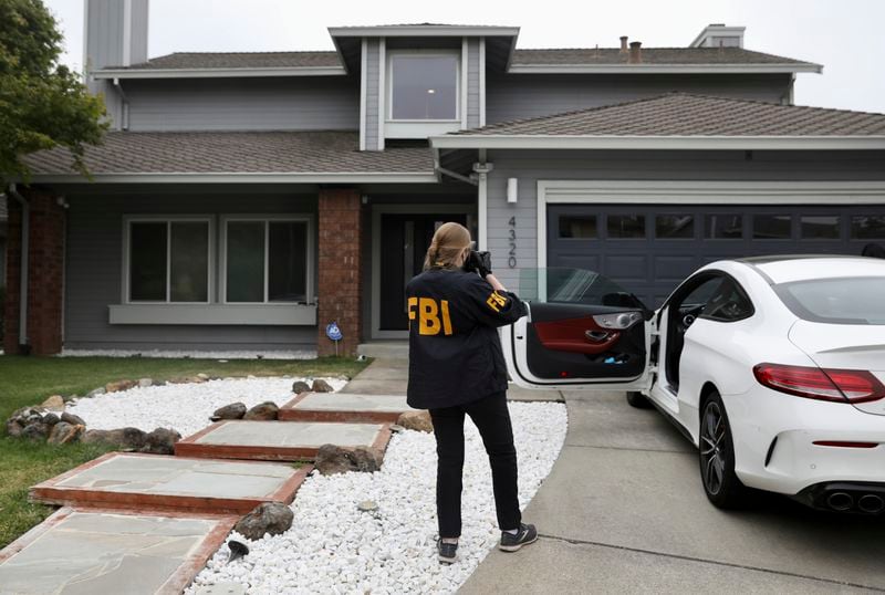 FBI agents raid a home on Viewcrest Court in Oakland, Calif. Thursday, June 20, 2024 in connection with another raid on Oakland Mayor Sheng Thai's home. Federal authorities raided a home belonging to Oakland Mayor Sheng Thao early Thursday as part of an investigation that included a search of at least two other houses, authorities said. (Jessica Christian/San Francisco Chronicle via AP)