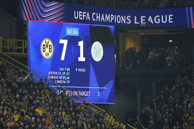 Dortmund fans watch the Champions League opening phase soccer match between Borussia Dortmund and Celtic FC at the BVB Stadion in Dortmund, Germany, Tuesday, Oct. 1, 2024. Dortmund won 7-1. (AP Photo/Martin Meissner)