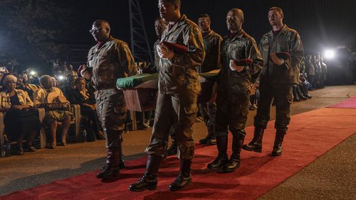 One of the remains of South Africans who died while exiled in Zimbabwe and Zambia during the struggle against white minority rule arrive at the Waterkloof Air Force Base in Pretoria, South Africa, Wednesday, Sept. 25, 2024. (AP Photo/Shiraaz Mohamed)