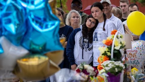 (Left to right) Maya Soto and Lana Kriskovic comfort each other at a Friday vigil in Winder. Earlier in the week four people were killed there in a shooting at Apalachee High School.