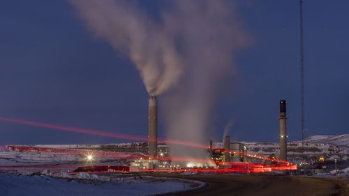 FILE - Taillights trace the path of a motor vehicle at the Naughton Power Plant, Jan. 13, 2022, in Kemmerer, Wyo., next to a site where Bill Gates and his energy company are starting construction on a next-generation nuclear plant. (AP Photo/Natalie Behring, File)