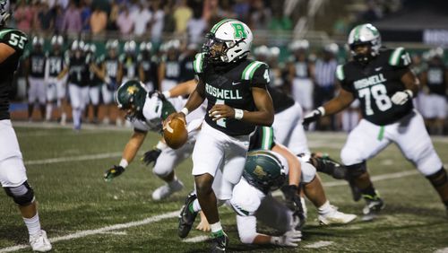 Roswell quarterback KJ Smith scrambles away from pressure during a 2022 game against Blessed Trinity. (Christina Matacotta/For the AJC)