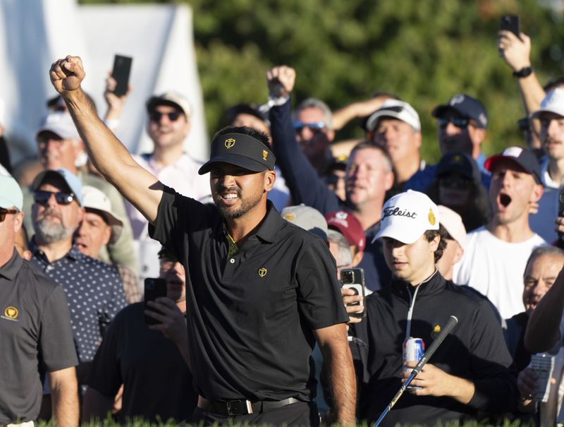 International team member Jason Day of Australia, celebrates after defeating the United States team on the eighteenth hole of their second round foursome match at the Presidents Cup golf tournament at the Royal Montreal Golf Club, in Montreal, Friday, Sept. 27, 2024. (Christinne Muschi/The Canadian Press via AP)