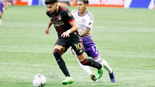 Atlanta United midfielder Marcelino Moreno (10) dribbles, leaving behind Orlando City midfielder Facundo Torres (17) during the second half at Mercedes-Benz Stadium on Sunday, July 17, 2022. Miguel Martinez /Miguel.martinezjimenez@ajc.com