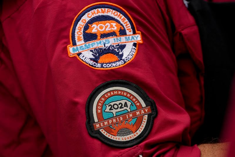 A member of the Sociedad Mexicano de Parrillieros team wears patches of the World Championship Barbecue Cooking Contest, Friday, May 17, 2024, in Memphis, Tenn. (AP Photo/George Walker IV)