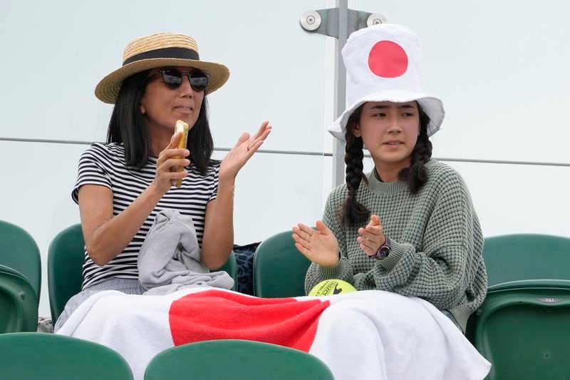 Spectactors watch the Naomi Osaka of Japan and Diane Parry of France during their first round match of the Wimbledon tennis championships in London, Monday, July 1, 2024. (AP Photo/Kirsty Wigglesworth)
