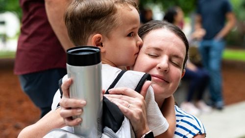 Kindergartner Anderson Kelly, 5, hugs his mother Bonnie Perdue on the first day of school at Glennwood Elementary School in Decatur on Tuesday, July 30, 2024. (Seeger Gray / AJC)
