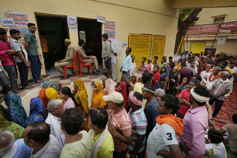 People stand in queue to cast their votes inside a polling station during the last round of a six-week-long national election in Varanasi, India, Saturday, June 1, 2024. The seventh and last round of voting in 57 constituencies across seven states and one union territory will complete polling for all 543 seats in the powerful lower house of parliament. Nearly 970 million voters more than 10% of the world’s population were eligible to elect a new parliament for five years. (AP Photo/Rajesh Kumar Singh)