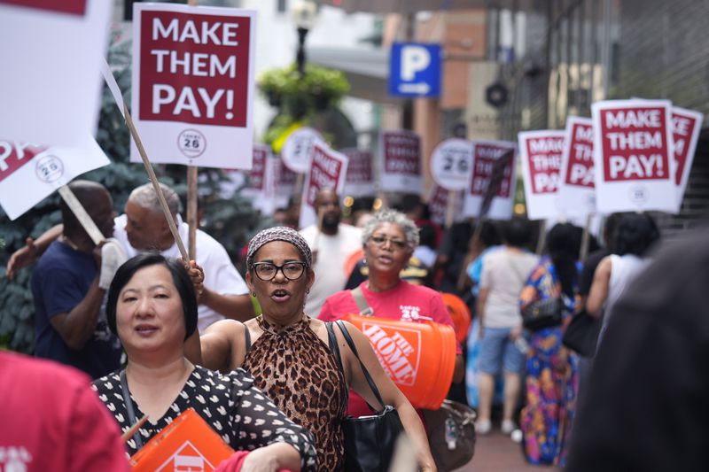 Union members from Local 26, representing workers in the hospitality industries of Massachusetts, picket outside the Hyatt Regency Boston, Wednesday, July 17, 2024, in Boston. (AP Photo/Charles Krupa)