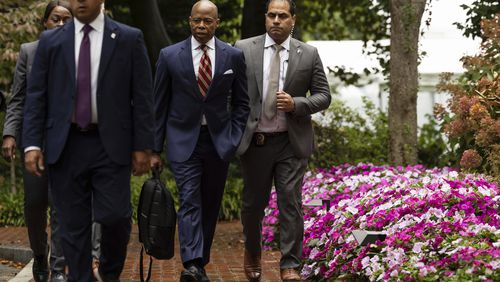 New York City Mayor Eric Adams, second right, exits Gracie Mansion, the official residence of the mayor, Thursday, Sept. 26, 2024, in New York. (AP Photo/Yuki Iwamura)