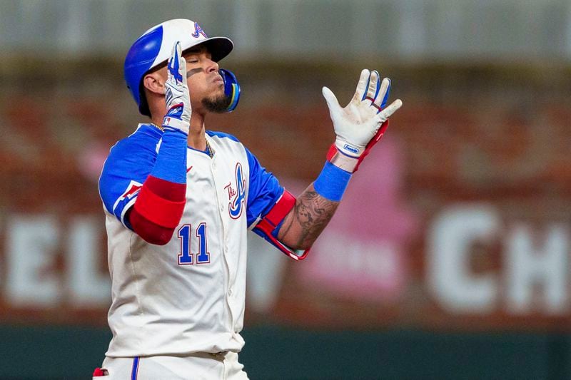 Atlanta Braves' Orlando Arcia (11) gives praise when he reaches second base after hitting a double to center field in the third inning of a baseball game against the Los Angeles Dodgers, Saturday, Sept. 14, 2024, in Atlanta. (AP Photo/Jason Allen)