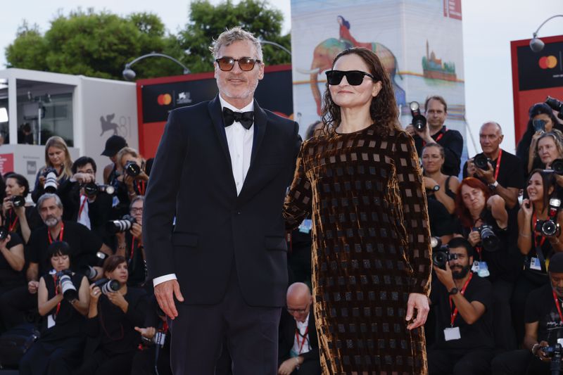 Joaquin Phoenix, left, and Rain Phoenix pose for photographers upon arrival for the premiere of the film 'Joker: Folie A Deux' during the 81st edition of the Venice Film Festival in Venice, Italy, on Wednesday, Sept. 4, 2024. (Photo by Joel C Ryan/Invision/AP)