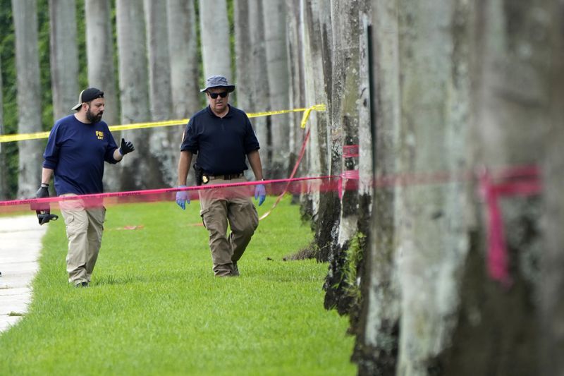 Law enforcement officials work outside of the Trump International Golf Club after the apparent assassination attempt of Republican presidential nominee and former President Donald Trump Monday, Sept. 16, 2024, in West Palm Beach, Fla. (AP Photo/Lynne Sladky)