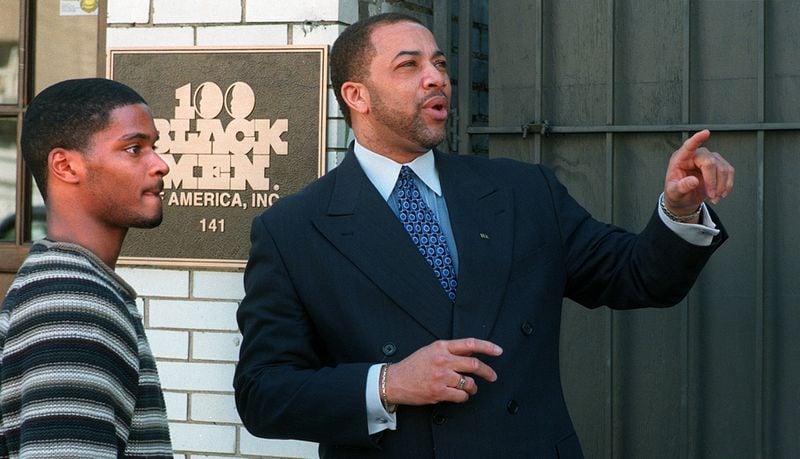 In a 1999 file photo, Thomas Dortch talks to 100 Black Men of American intern Gabriel Miller outside of the Auburn Avenue office.(NICK ARROYO/AJC STAFF)
