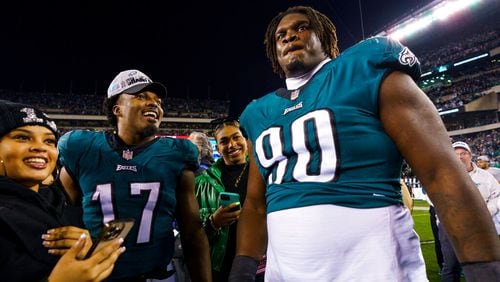 Philadelphia Eagles defensive tackle Jordan Davis (90) celebrates the win with linebacker Nakobe Dean (17) following the NFC Championship NFL football game against the San Francisco 49ers, Sunday, Jan. 29, 2023, in Philadelphia. (AP Photo/Chris Szagola)