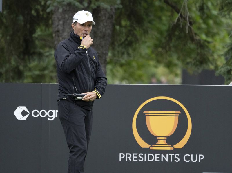 International team captain Mike Weir speaks on a radio during a practice session for the Presidents Cup golf tournament at Royal Montreal Golf Club in Montreal, Wednesday, Sept. 25, 2024. (Ryan Remiorz/The Canadian Press via AP)