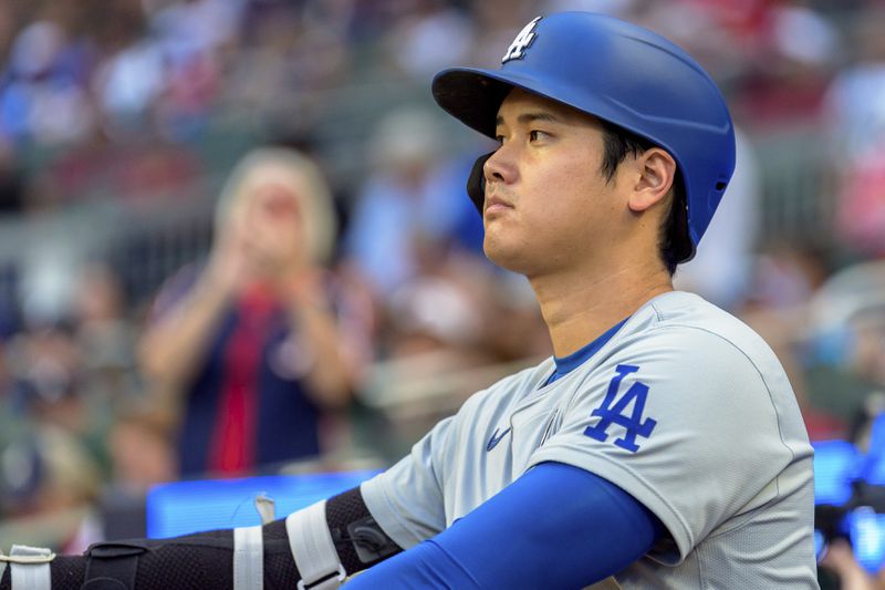 Los Angeles Dodgers' Shohei Ohtani awaits his turn to bat in the first inning of a baseball game against the Atlanta Braves, Sunday, Sept. 15, 2024, in Atlanta. (AP Photo/Jason Allen)