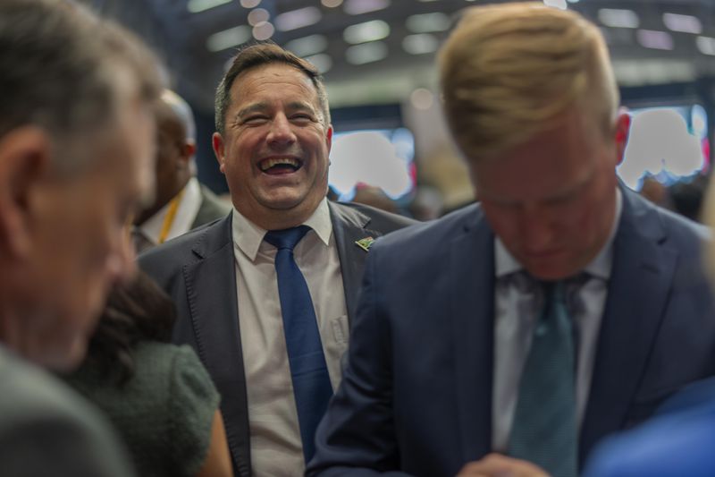 Democratic Alliance leader John Steenhuisen laughs at the end of the swearing in ceremony for members of parliament in Cape Town, South Africa, ahead of an expected vote by lawmakers to decide if South African président Cyril Ramaphosa is re-elected as leader of the country, Friday, June 14, 2024. (AP Photo/Jerome Delay)
